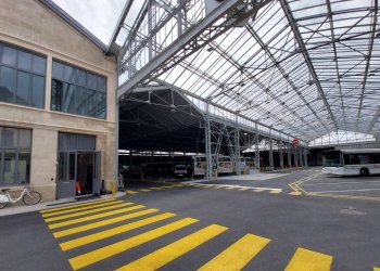 Vue de la Halle Lescure, le bâtiment, la verrière avec des bus en arrière plan